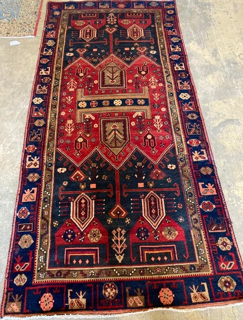 A Caucasian design blue ground geometric rug, 140 x 300cm